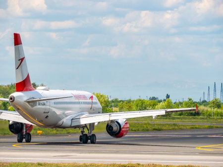 Otopeni, Romania - 05.15.2021: A Austrian Airlines Airbus 319-112 (OE-LDA) airplane on the airport runway at Henri Coanda International Airport.のeditorial素材