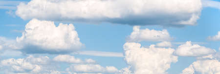 Panoramic picture with Fluffy White Clouds on a blue sky.の写真素材
