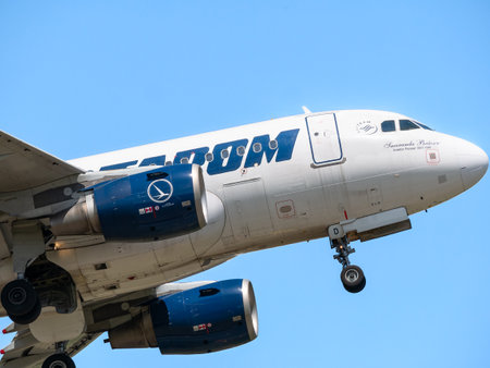 Bucharest, Romania - 05.14.2021: YR-ASD TAROM Airbus A318-111 airplane flying against clear blue sky. Close up detail.のeditorial素材