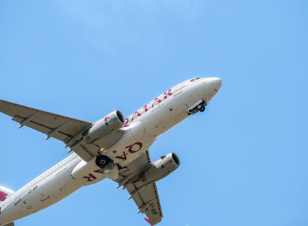 Otopeni, Romania - 05.14.2021: Qatar Airways Airbus A320-232 (A7-AHP) flying against blue sky. Airplane takes off from Henry Coanda International Airport.のeditorial素材