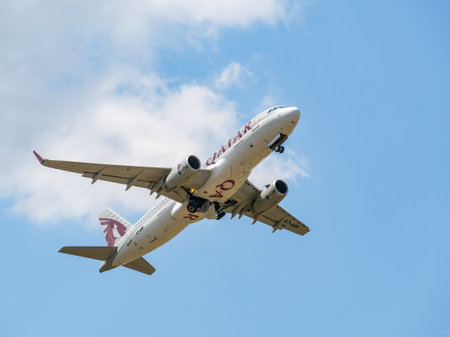 Otopeni, Romania - 05.14.2021: Qatar Airways Airbus A320-232 (A7-AHP) flying against blue sky. Airplane takes off from Henry Coanda International Airport.のeditorial素材