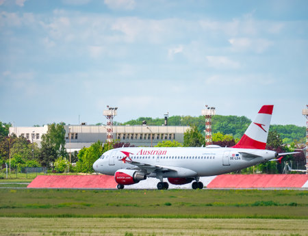Otopeni, Romania - 05.15.2021: A Austrian Airlines Airbus 319-112 (OE-LDA) airplane on the airport runway at Henri Coanda International Airport.のeditorial素材