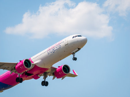 Otopeni, Romania - 05.11.2021: A Wizz Air Airbus A321-271 NX (HA-LVD) airplane flying against blue cloudy sky from Henri Coanda International Airport.のeditorial素材