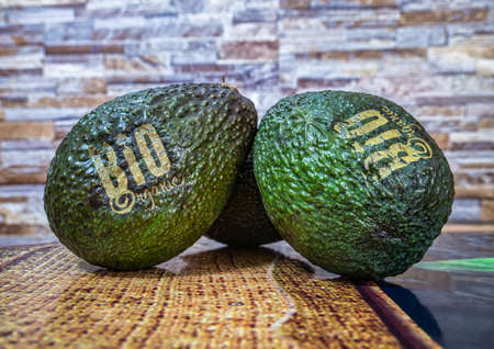 Close up detail photo with two avocado fresh organic bio fruit on the kitchen tableの写真素材