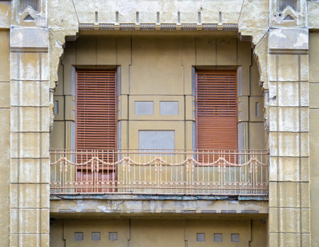 Old architectural detail of a elegant balcony with wooden shutters covering the windows in Timisoara, Romaniaの写真素材