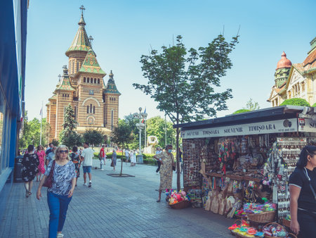 Timisoara, Romania - 06.19.2021:Scene from the center of Timisoara with the Orthodox Metropolitan Cathedral (Catedrala MitropolitanÄ OrtodoxÄ)and a souvenir shopのeditorial素材