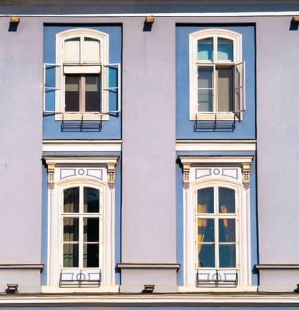 Architectural detail of two blue colored wooden framed windowsの写真素材
