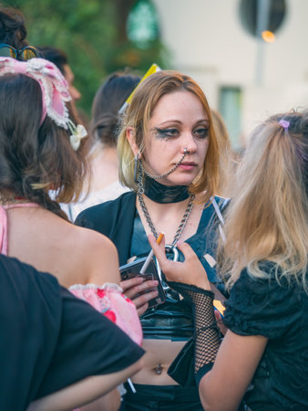 Bucharest, Romania - 08.14.2021: Young girl with many piercings on her face at LGBTQ Pride parade rally .のeditorial素材