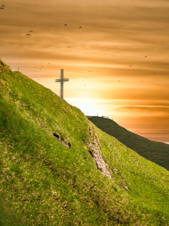 View with the Heroes Cross on Caraiman peak at sunset, in Bucegi Mountains Romania.の写真素材