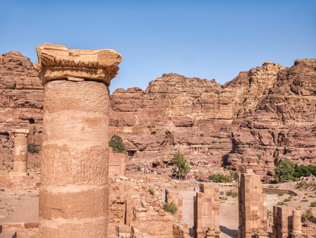 The Colonnaded Street in the ancient city of Petra, Jordan and a red rock mountain in the backgroundの写真素材