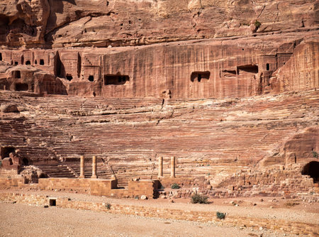 The Nabatean amphitheatre in the ancient city of Petra, Jordan. Theatre with row of seats and stairways carved into the side of the mountain.の写真素材