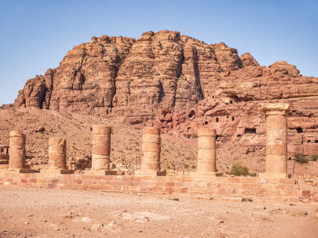 The Colonnaded Street in the ancient city of Petra, Jordan and a red rock mountain in the backgroundの写真素材