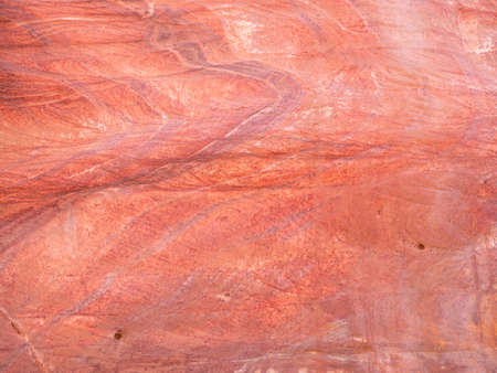 Red rock stone sand texture background. Red Stone wall in Petra, Jordan.の写真素材