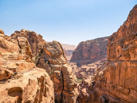 Mountain wall of red sand rock that surround the ancient city of Petra, Jordan. Rocky desesrt landscapeの写真素材