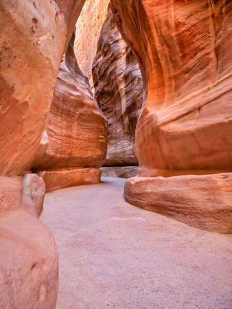 Picture with al-Siq, the natural passage through red rock walls which is main entrance to the ancient Nabatean city of Petra in southern Jordan.の写真素材