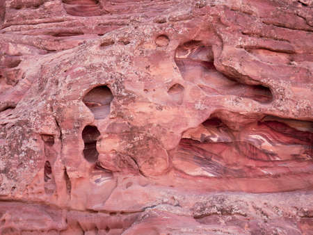Red rock stone sand texture background. Red Stone wall in Petra, Jordan.の写真素材