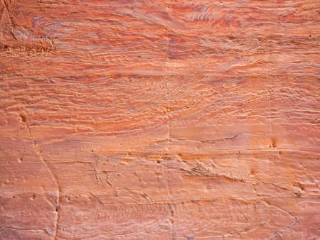 Red rock stone sand texture background. Red Stone wall in Petra, Jordan.の写真素材