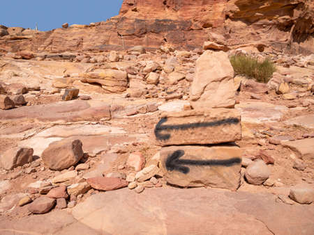 Black arrows marks or signs indicating the Al-Khubtha Trail in Petra,Jordan.の写真素材