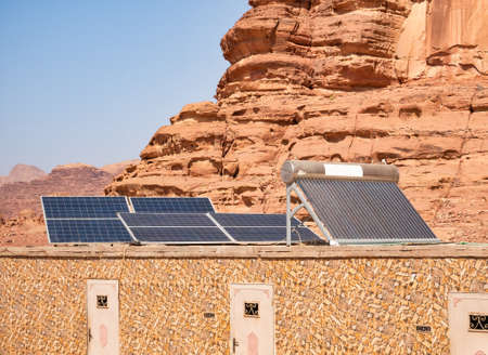 Photovoltaic solar panels on top of a building in Wadi Rum desert, Jordanの写真素材