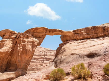 Um Frouth Rock Bridge, a high natural rock bridge in Wadi Rum desert, Jordan.の写真素材
