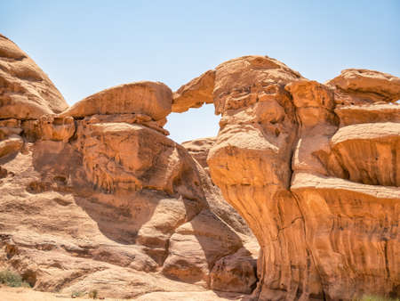 Um Frouth Rock Bridge, a high natural rock bridge in Wadi Rum desert, Jordan.の写真素材