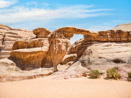 Um Frouth Rock Bridge, a high natural rock bridge in Wadi Rum desert, Jordan.の写真素材