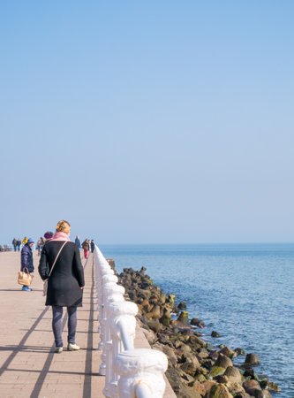 Constanta, Romania - 02.25.2021: People walking or strolling on the seafront (Faleza Cazino) enjoying a nice day out.のeditorial素材