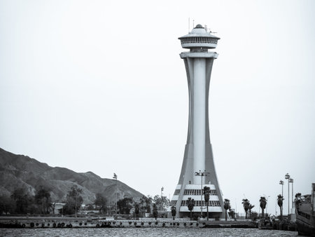 Aqaba, Jordan - 09.01.2021: Scenic view at sunset with Aqaba Port Observation or control Tower, Jordan. Lighthouse black and white.のeditorial素材