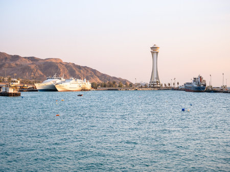 Aqaba, Jordan - 09.01.2021: Scenic view at sunset with Aqaba Port Observation or control Tower, Jordan. Lighthouse at sunsetのeditorial素材