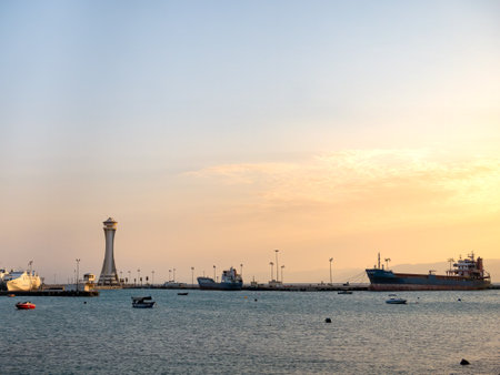 Aqaba, Jordan - 09.01.2021: Scenic view at sunset with Aqaba Port Observation or control Tower, Jordan. Lighthouse at sunsetのeditorial素材