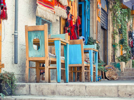 Colorful scene with blue wooden table and chairs with on Jadal (for Knowledge and Culture) staircases in Amman, Jordan.の写真素材