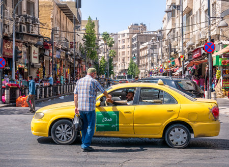 Amman, Jordan - 09.02.2021: Taxi driver in Amman receiving the payment from a customerのeditorial素材
