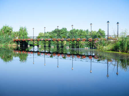 Scenic view with with a bridge reflecting in the water over Comana lake part of Comana Natural Park, located near Bucharest, Romania.の写真素材