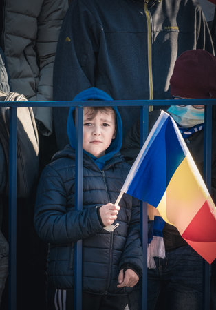 Bucharest, Romania - 12.01.2021: Children holding the national flag attending at the unity day national military parade in Bucharest.のeditorial素材