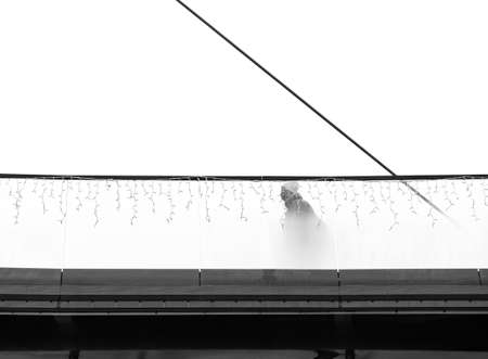 Unidentified Person walking on a bridge in the park. Monochrome landscape in Moghioros (Drumul Taberei ) park in Bucharest, Romania.の写真素材