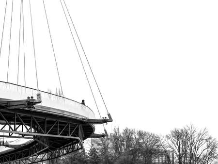 Unidentified Person on a bridge looking in the distance . Monochrome minimalist landscape in Moghioros (Drumul Taberei ) park in Bucharest, Romania.の写真素材