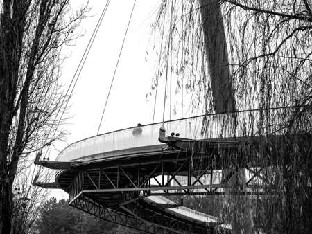 Man walking on a bridge in the park. Monochrome landscape in Moghioros (Drumul Taberei ) park in Bucharest, Romania.の写真素材