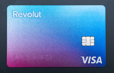 Bucharest, Romania - 03.25.2022: Close up with a Visa Revolut bank credit or debit card .のeditorial素材