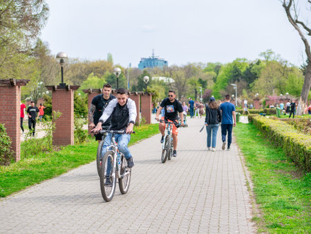 Bucharest, Romania - 04.15.2022: Busy weekend with many tourists and locals out for a stroll in King Mihai I park (Herestrau)のeditorial素材