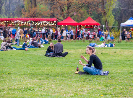 Bucharest, Romania - 04.15.2022: People relaxing and having fun on the grass in KIng MIhai I park (Herestrau), in Bucharestのeditorial素材