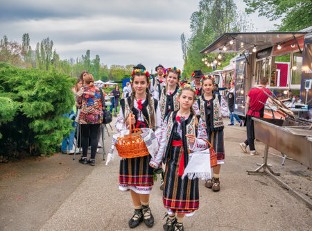 Bucharest, Romania - 04.15.2022:Children dressed in traditional popular romanian clothes at a food festival in KIng MIhai I park (Herestrau), in Bucharestのeditorial素材
