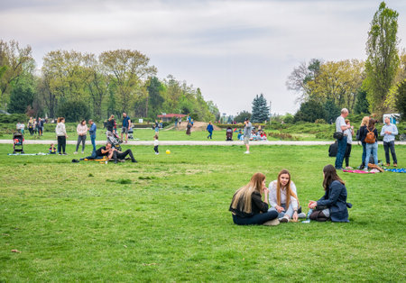 Bucharest, Romania - 04.15.2022: People relaxing and having fun on the grass in KIng MIhai I park (Herestrau), in Bucharestのeditorial素材