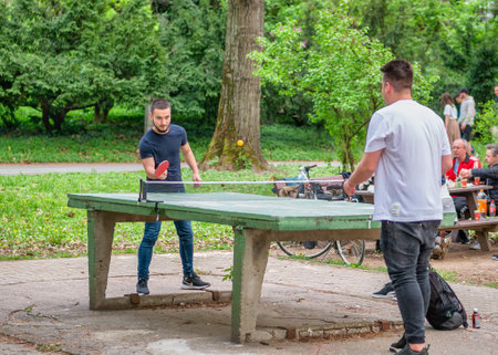Bucharest, Romania - 04.15.2022: People playing tennis table or ping-pong in King Mihai I park (Herestrau).のeditorial素材