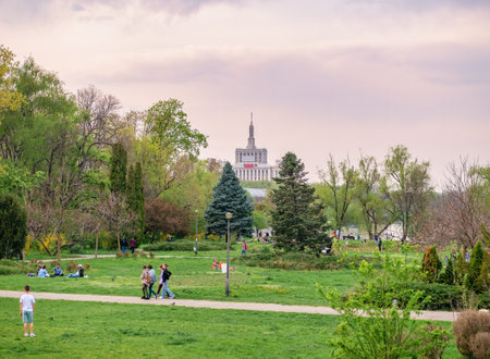 Bucharest, Romania - 04.15.2022: People relaxing and having fun on the grass in KIng MIhai I park (Herestrau), in Bucharestのeditorial素材