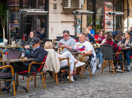 Bucharest, Romania - 04.08.2022: Tourists and locals at a outdor restaurant and cafe having a drink in the center of Bucharestのeditorial素材