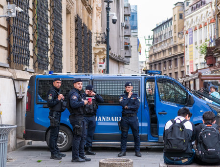 Bucharest, Romania - 04.08.2022: Police officers and Gendarmerie or military police in front of a van in the old town center, Bucharestのeditorial素材
