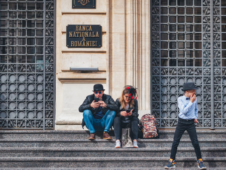 Bucharest, Romania - 04.08.2022:Costumed couple and a child in front of the National Romanian Bank in the old town center of Bucharest.のeditorial素材