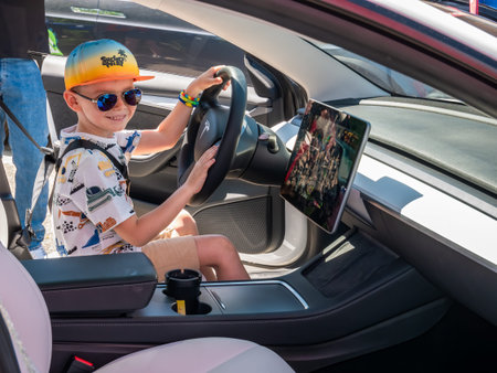 Bucharest, Romania - 05.20.2022: Happy young adult on the driver s seat in a Tesla Model 3.