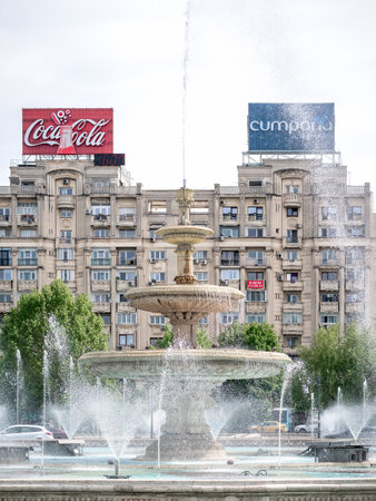 Bucharest,Romania - June 2022: Unirii Square in the center of Bucharest with water fountains and buidings against the skyのeditorial素材