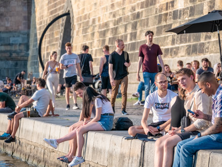 Prague, Czech Republic - June 2022: Tourists and locals sitting and having a beer on Naplavka along the Vltava river, in Pragueのeditorial素材